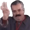 Mann mit Bart macht eine scherzhafte Geste mit den Fingern und lächelt. Mann mit Bart und grauem Haar macht mit der Hand eine Geste, als würde er sich verabschieden oder etwas wegwischen.